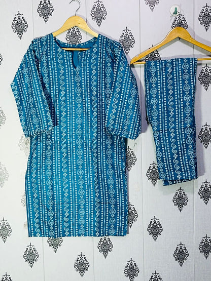 Blue patterned kurta with pants hanging on a wooden hanger against a decorative wall.